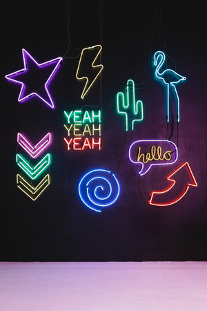 Colorful neon light decoration signs on the black wallの写真素材