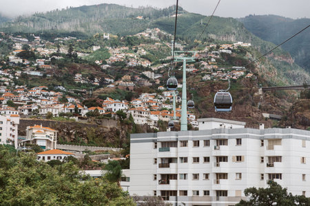 Cable car with cabins above city Funchal, Madeira Island, Portugalの写真素材