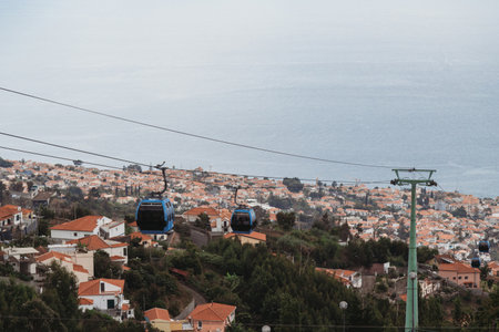 Cable car with cabins above the Atlantic ocean and city Funchal, Madeira Island, Portugalの写真素材