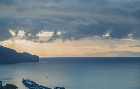 Sunrise over the Atlantic ocean in Funchal, Madeira island, Portugalの写真素材