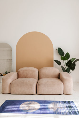 Interior of light modern living room with beige couch and yoga mat