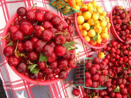 lots of different cherries in basketsの写真素材