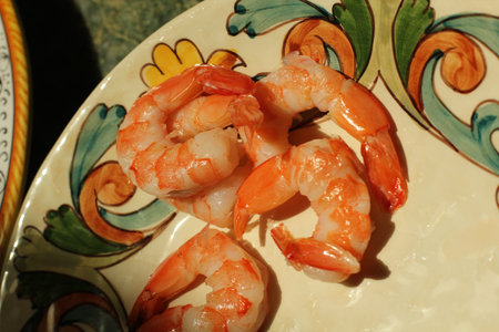 cooked shrimp on a plate in sunlightの写真素材