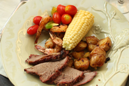 outdoor lunch with corn and meatの写真素材