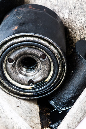 Some mechanical parts with exhaust oil in a landfillの写真素材