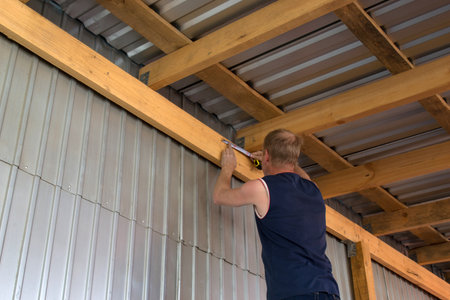 Work takes measurements on the ceiling beamの写真素材