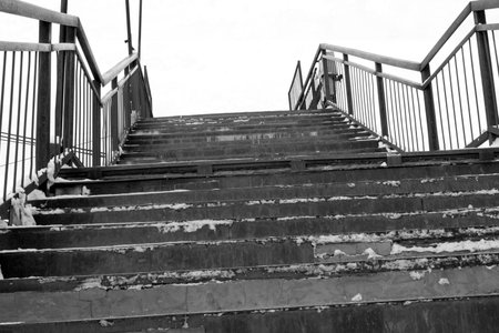 Pedestrian bridge over the railway. Stairs. Black and white