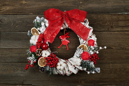 Christmas wreath on the brown wooden backgroundの写真素材