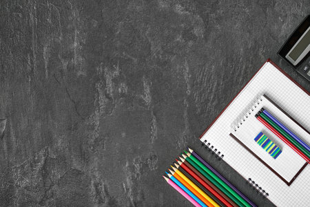Notepad over school and office supplies on office tableの写真素材