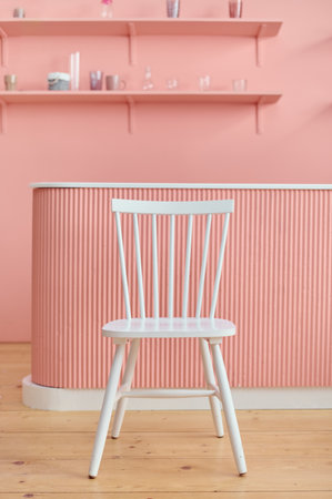 White chair in the kitchen pink background and wooden floor. minimal concept.の写真素材
