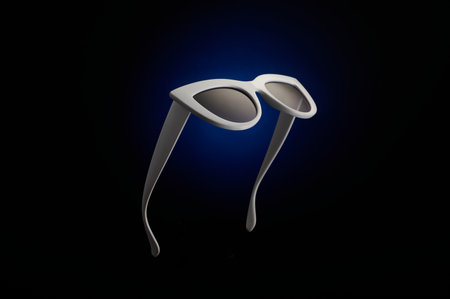 Stylish white sunglasses on a black and blue background.