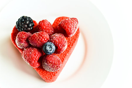 Heart shaped cake with berries on top  As a trivial gift for a Valentine s Day
