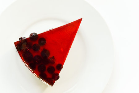 Appetizing piece of cake with black currant jelly 