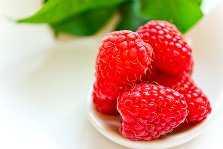Fresh raspberries on a light background