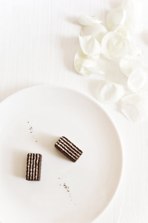 Chocolate wafers with a dairy stuffing on a white plateの写真素材