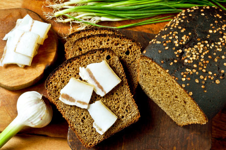 Ukrainian meal: black bread with slices of bacon as savory snacks.の写真素材