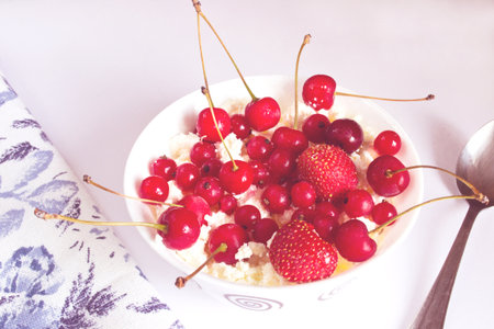 Cottage cheese with fresh berries, honey and nuts for breakfast