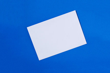 Blank sheet of paper on a blue backgroundの写真素材