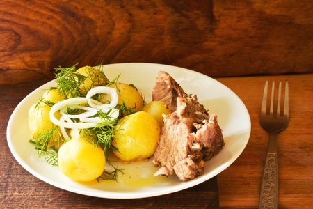 Fried meat with potato in dishの写真素材