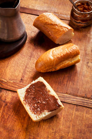 Crunchy French baguettes and chocolate for breakfast on dark wooden table, selective focusの写真素材
