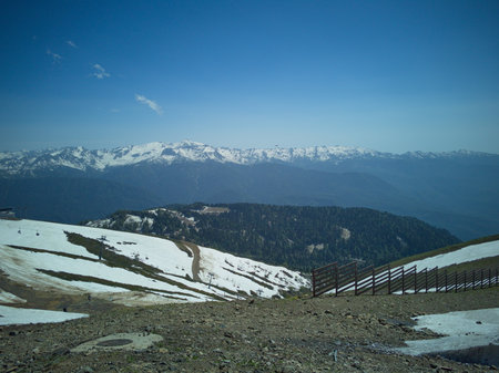 Beautiful mountain landscape with snow-capped peaks and blue skyの写真素材