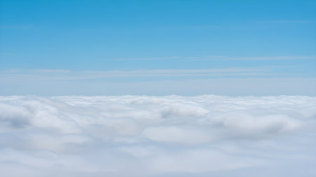 Beautiful aerial view of fluffy white clouds under a clear blue sky, symbolizing peace, freedom, travel, and natural beauty.の素材
