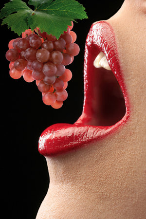 A sexy girl eating a sweet grapeの写真素材
