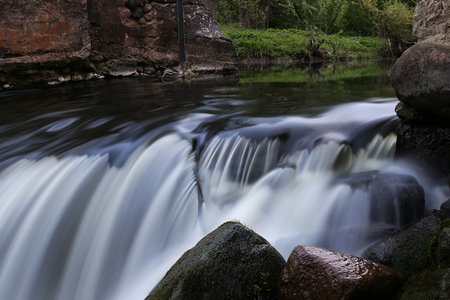 the flow of water in a small forest river, Stones in the foregroundの写真素材