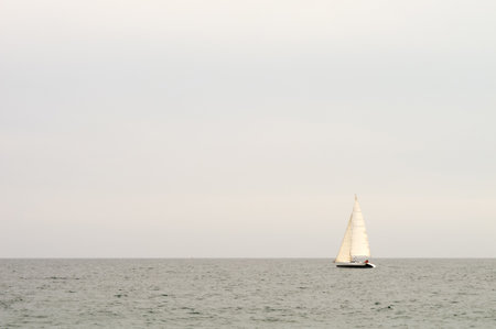 Sailboat sailing solo by calmの写真素材