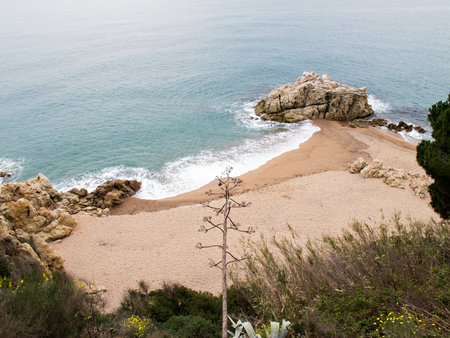 View of a secluded beach on the coast of Barcelona in Spain