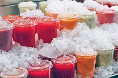 Assorted cut fruits in a marketの写真素材