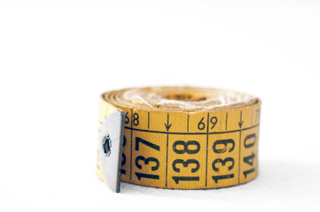 Detail of an old tape measure of tailoring
