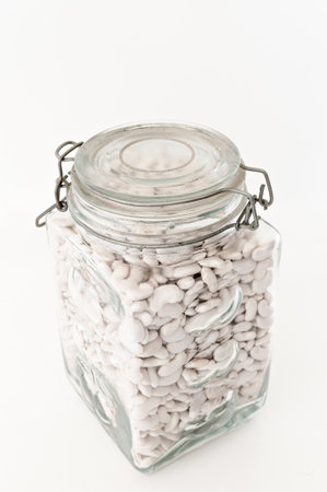 Glass jar with white beansの写真素材