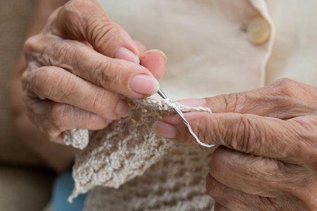 Detail of the hands of an elderly person crocheting