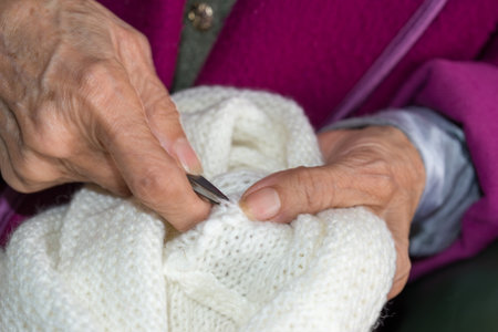 Detail of the hands of a person sewing