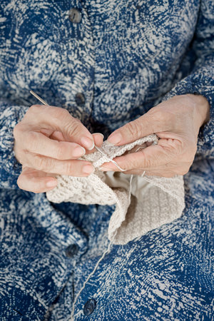 Detail of the hands of an elderly person crochetingの写真素材