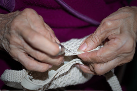 Detail of the hands of a person sewingの写真素材