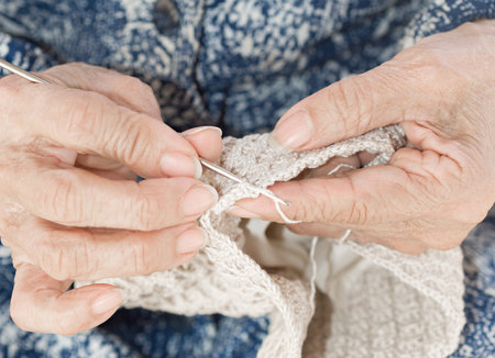 Detail of the hands of an elderly person crochetingの写真素材