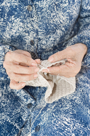 Detail of the hands of an elderly person crochetingの写真素材