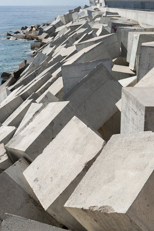 Breakwater consisting of concrete cubes for the protection of a portの写真素材