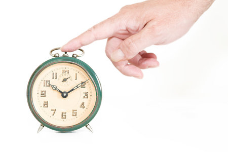 Hand for an stop old alarm clockの写真素材