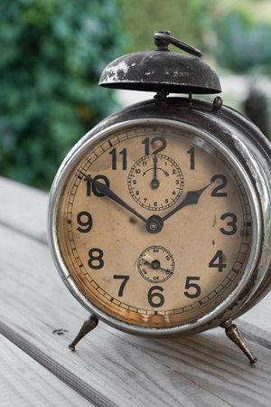 Detail of an old clock in an environment with plantsの写真素材