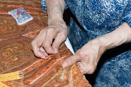Details of a dressmaker weaving a cushion
