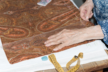 Details of a dressmaker weaving a cushion