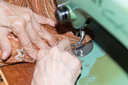 Details of a dressmaker weaving a cushionの写真素材