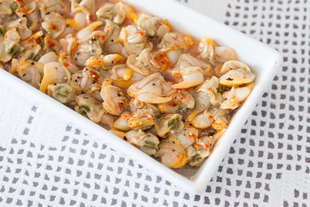 Cockles with red pepper and black pepperの写真素材