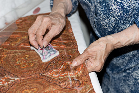 Details of a dressmaker weaving a cushionの写真素材