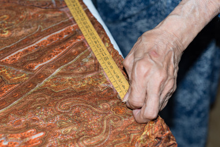 Details of a dressmaker weaving a cushion