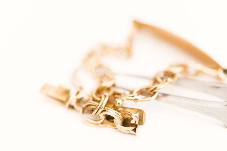 Detail of a gold bracelet on white backgroundの写真素材