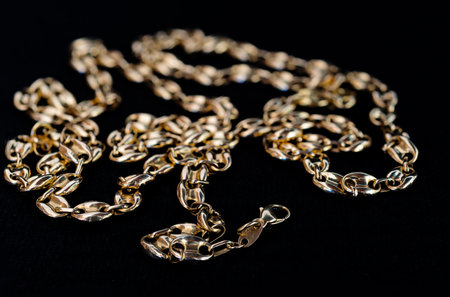 Detail of a gold chain on black background